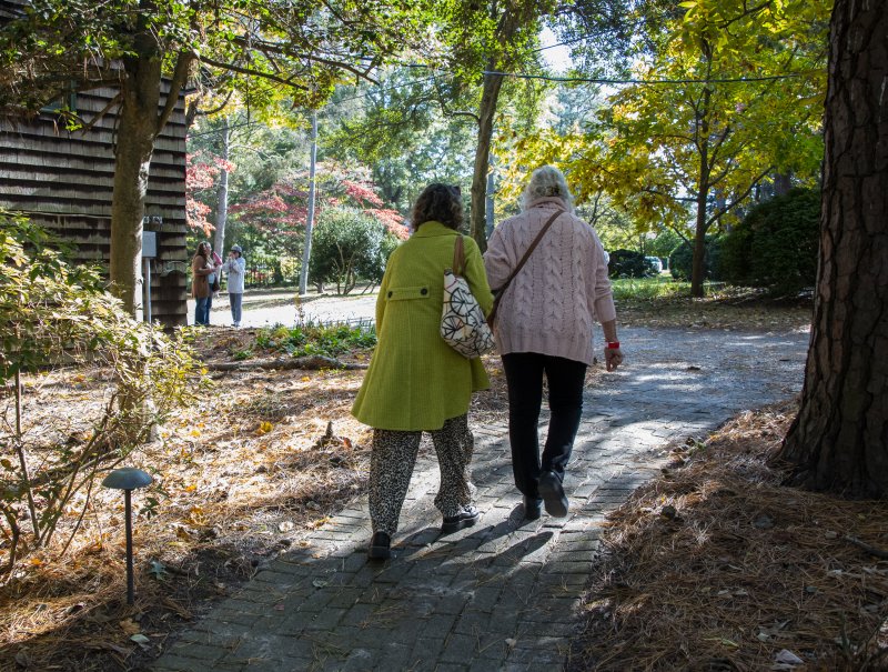 A couple of friends roam the grounds of the Rehoboth Art League, evoking the feeling of "A Walk to the Paradise Garden" by W. Eugene Smith.